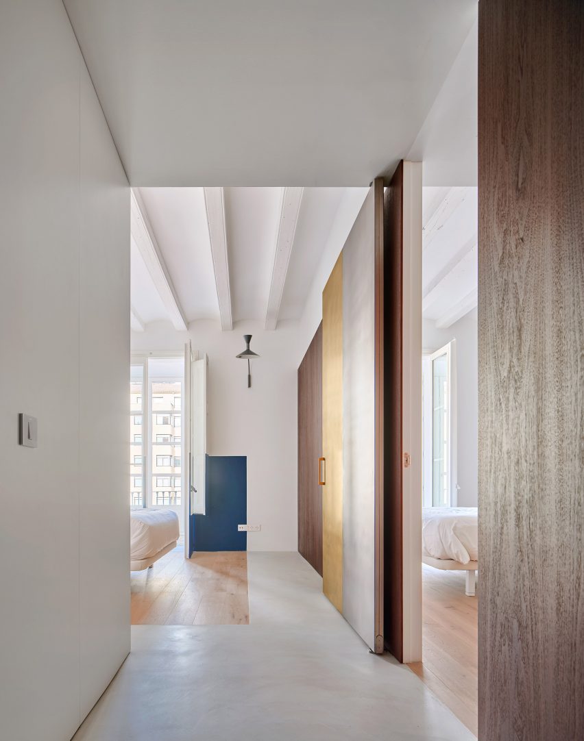 Girona Street apartment designed by Raúl Sanchez Architects features walnut wood wall