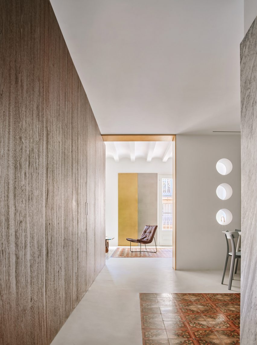 Girona Street apartment designed by Raúl Sanchez Architects features walnut wood wall