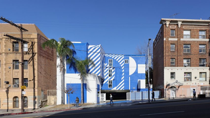 Exterior of the The Alvarado homeless shelter in LA with a graphic blue and white-painted facade