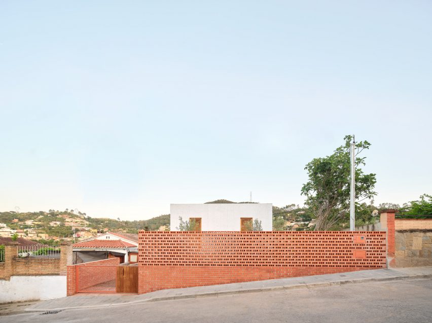Exterior of House on a Brick Base by Agora Arquitectura