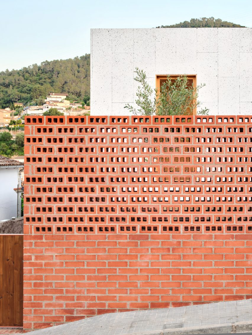 Exterior of House on a Brick Base by Agora Arquitectura