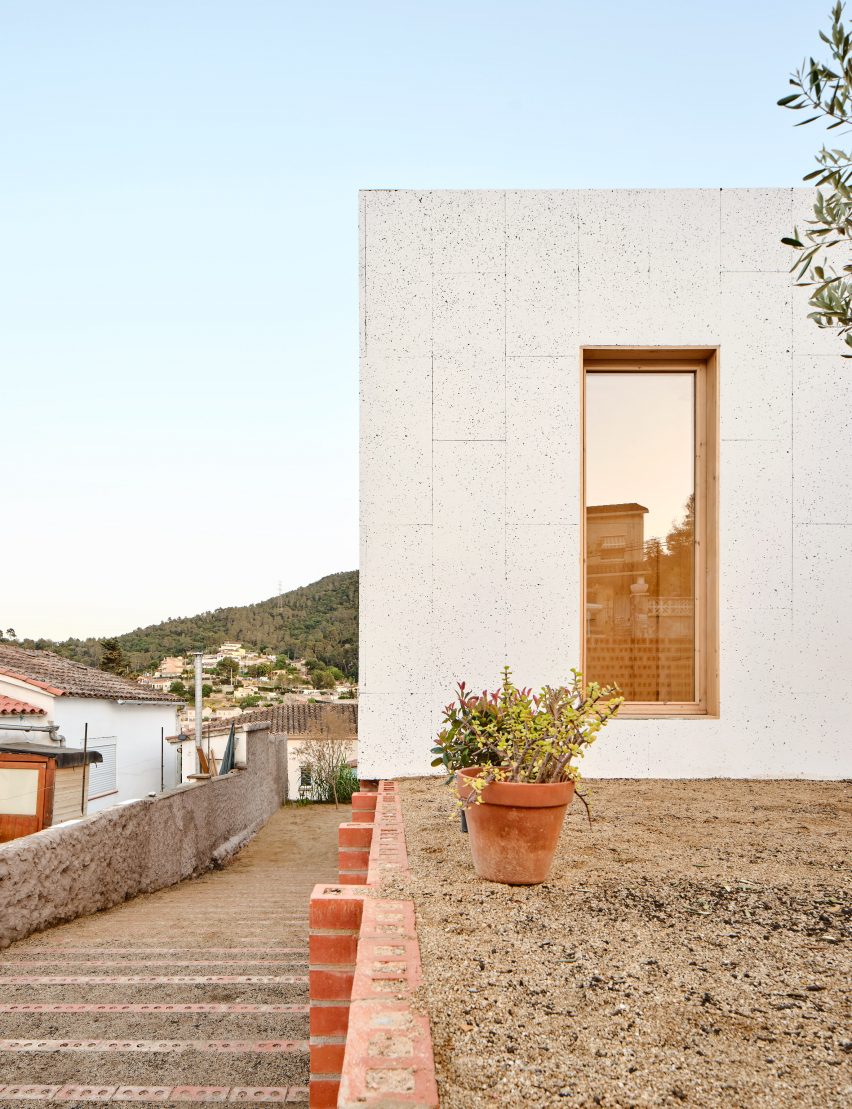 Exterior of House on a Brick Base by Agora Arquitectura