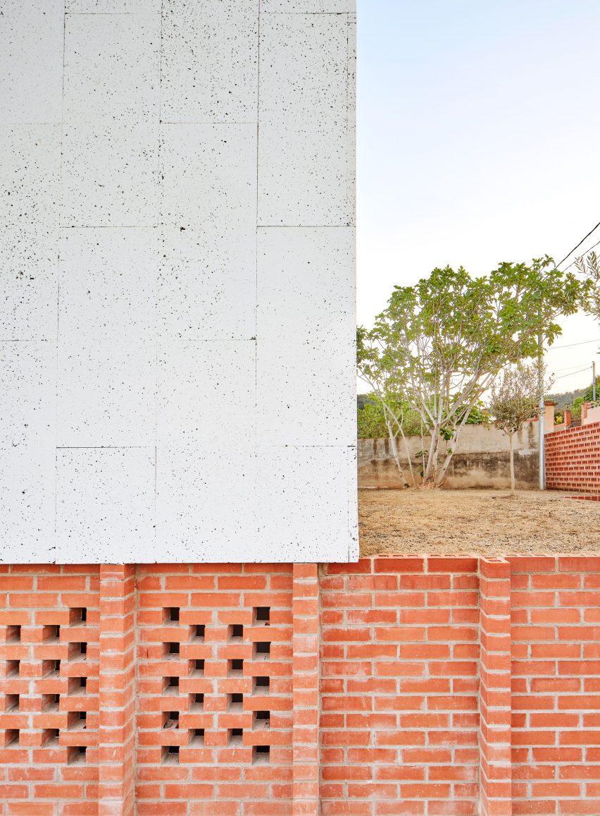 Exterior of House on a Brick Base by Agora Arquitectura