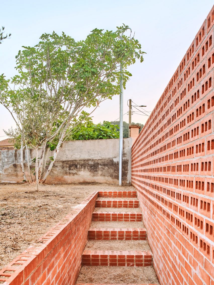 Exterior of House on a Brick Base by Agora Arquitectura