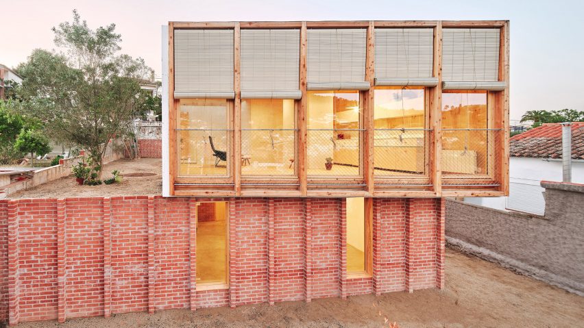 Exterior of House on a Brick Base by Agora Arquitectura