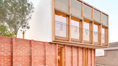 Exterior of House on a Brick Base by Agora Arquitectura
