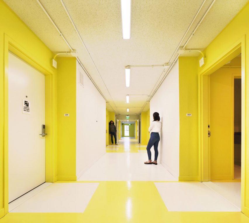 Yellow and white internal corridor at The Alvarado by Kadre Architects