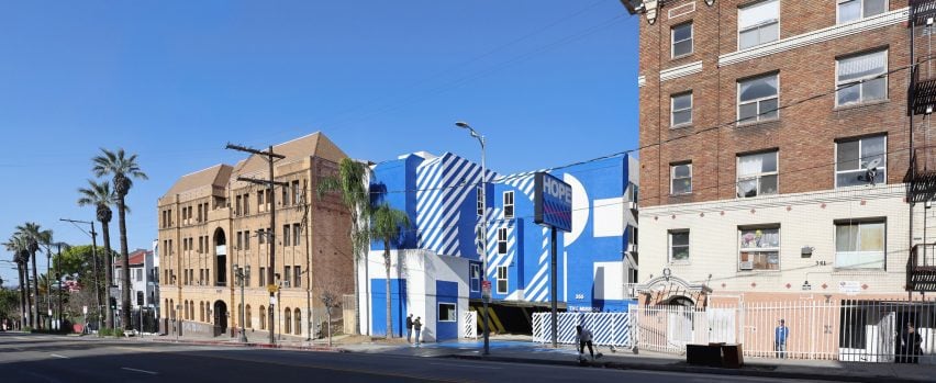 Exterior of the The Alvarado homeless shelter in LA with a graphic blue and white-painted facade