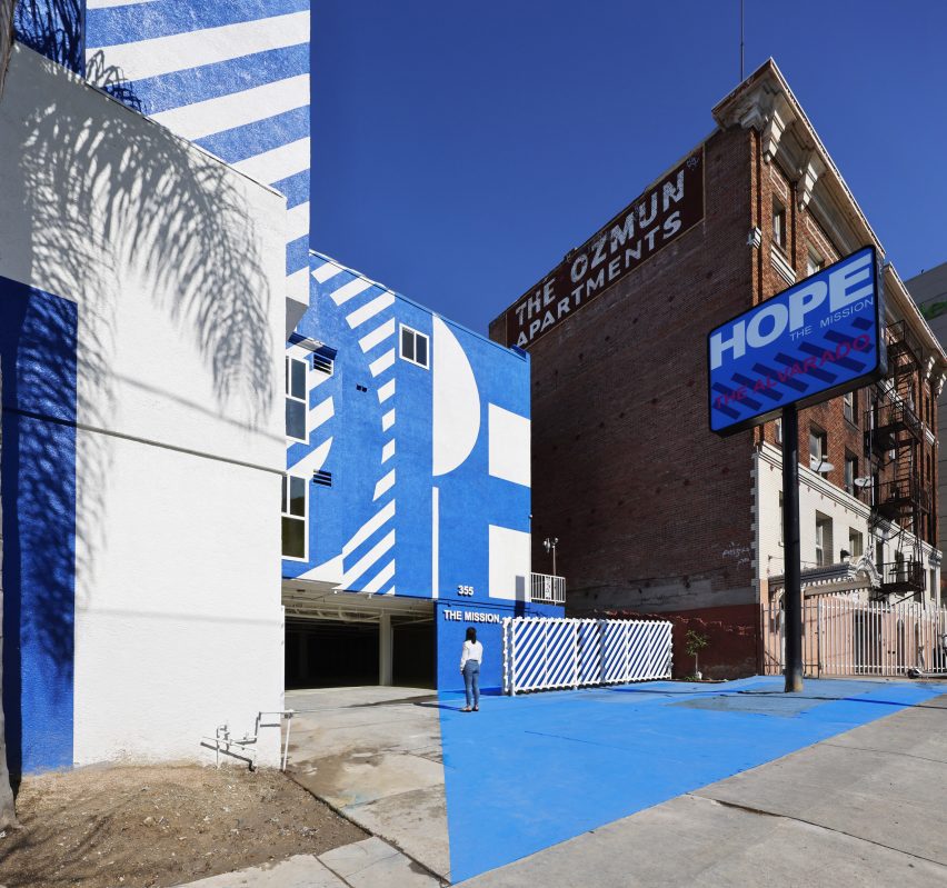 Exterior of the The Alvarado homeless shelter in LA with a graphic blue and white-painted facade