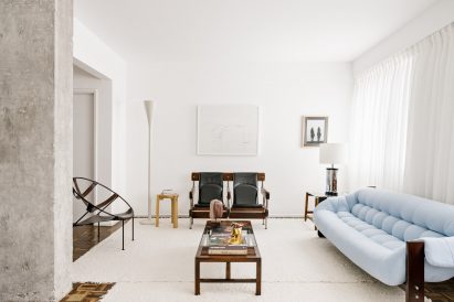 Living room with blue sofa and vintage furniture pieces