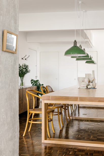 Wooden dining table with an assortment of caned chairs