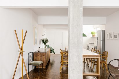 Wooden dining table and chairs atop parquet floor