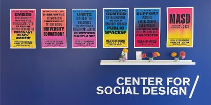Multicoloured posters on dark blue wall with white shelf below
