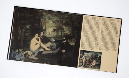 A flat lay of a book showing an old painting and text
