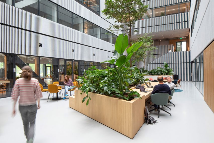 Atrium space at Matrix One by MVRDV with wooden planters