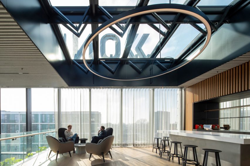 A bar with wood floors and glazed walls at Matrix One by MVRDV