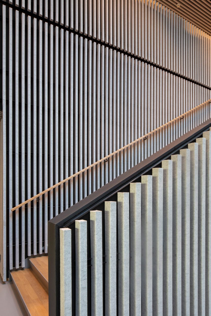 Staircase with felt panelled walls and wood steps