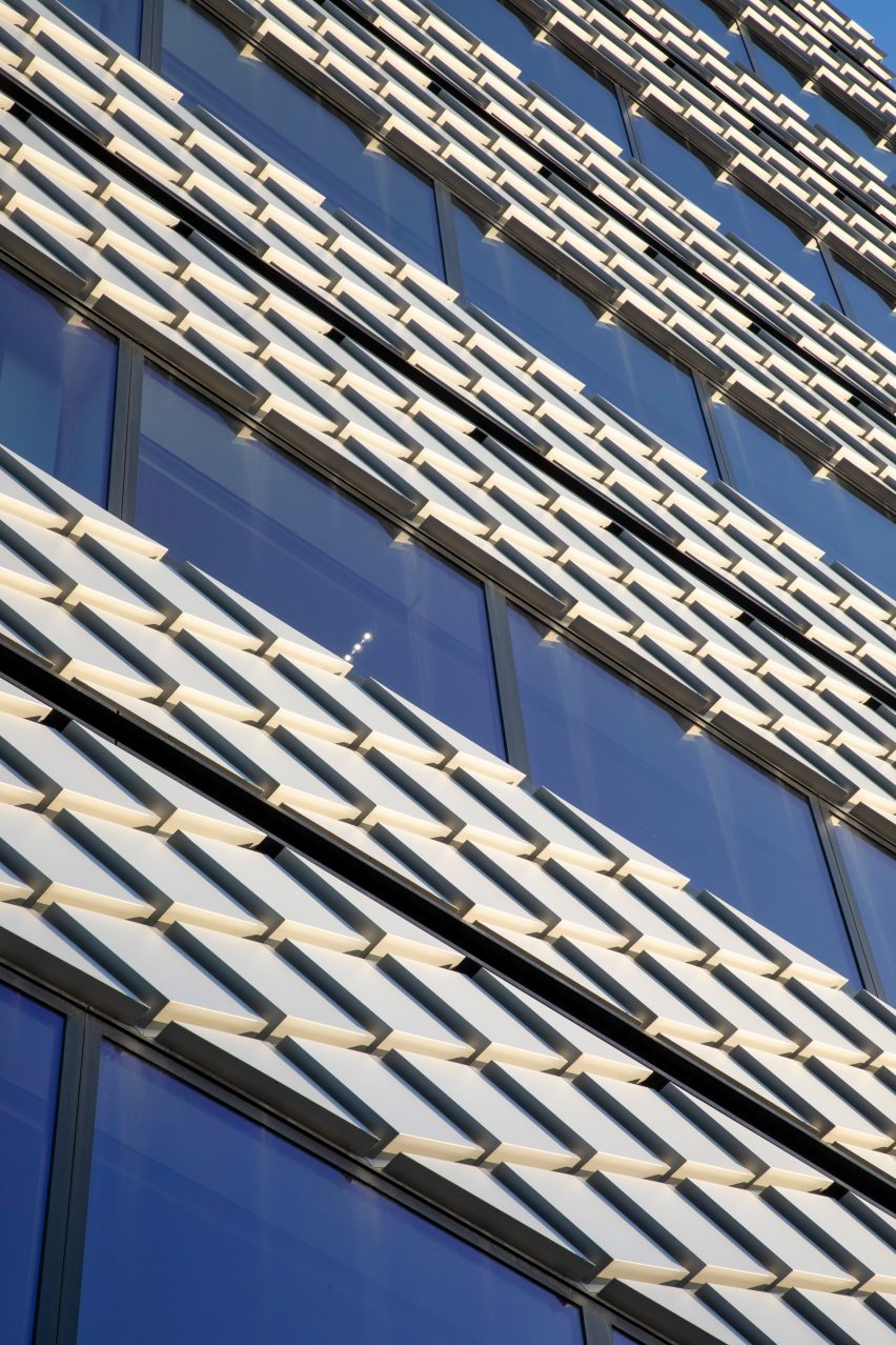 Exterior of a building with glazed walls ad diamond-shaped aluminium cladding