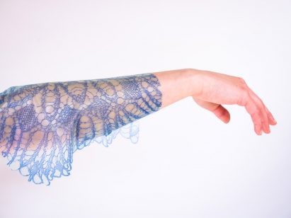 Arm draped in blue lacey fabric