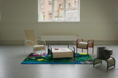 Series of furniture and rug in interior in front of window