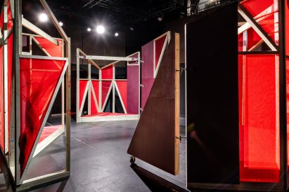 Triangular stages with timber frames and red netting built by school children and Matt+Fiona