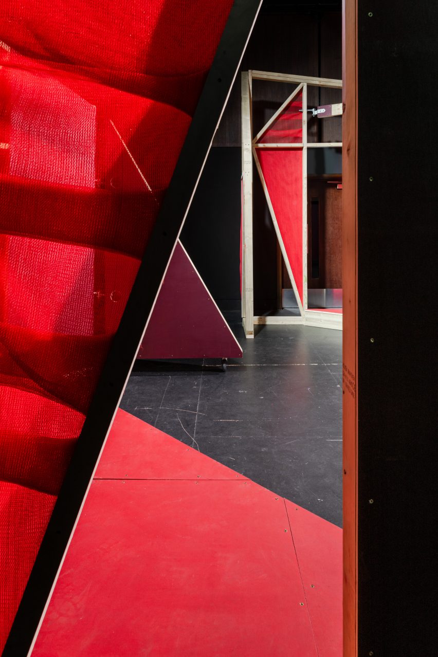 Triangular stages with timber frames and red netting built by school children and Matt+Fiona