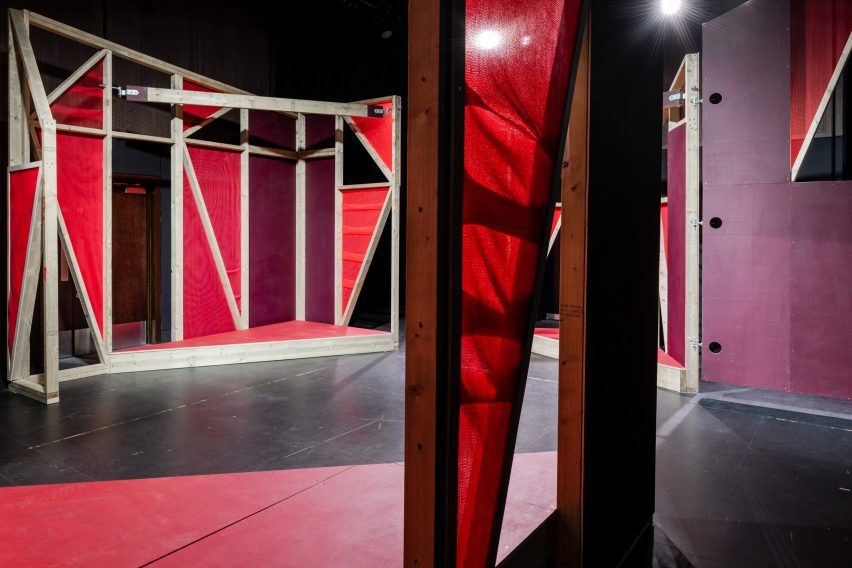 Triangular stages with timber frames and red netting built by school children and Matt+Fiona