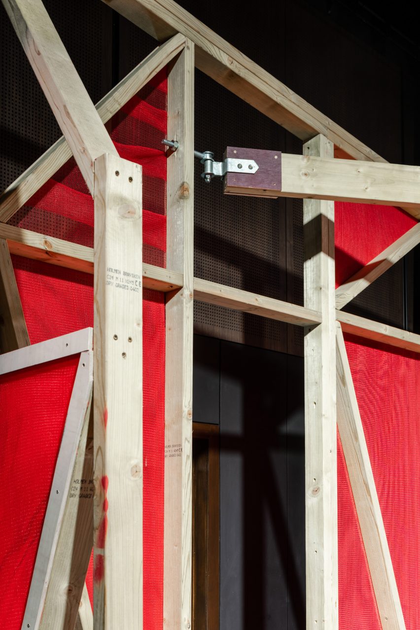 Triangular stages with timber frames and red netting built by school children and Matt+Fiona