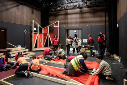 Children building timber-framed stages in Brixton
