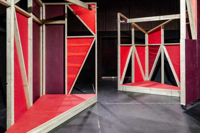 Triangular stages with timber frames and red netting built by school children and Matt+Fiona