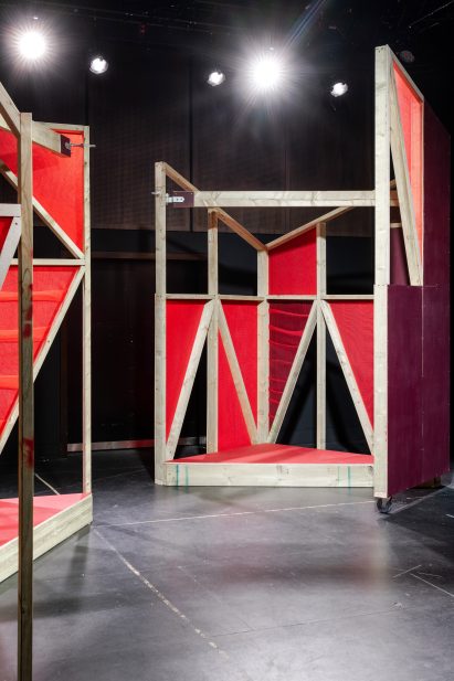 Triangular stages with timber frames and red netting built by school children and Matt+Fiona