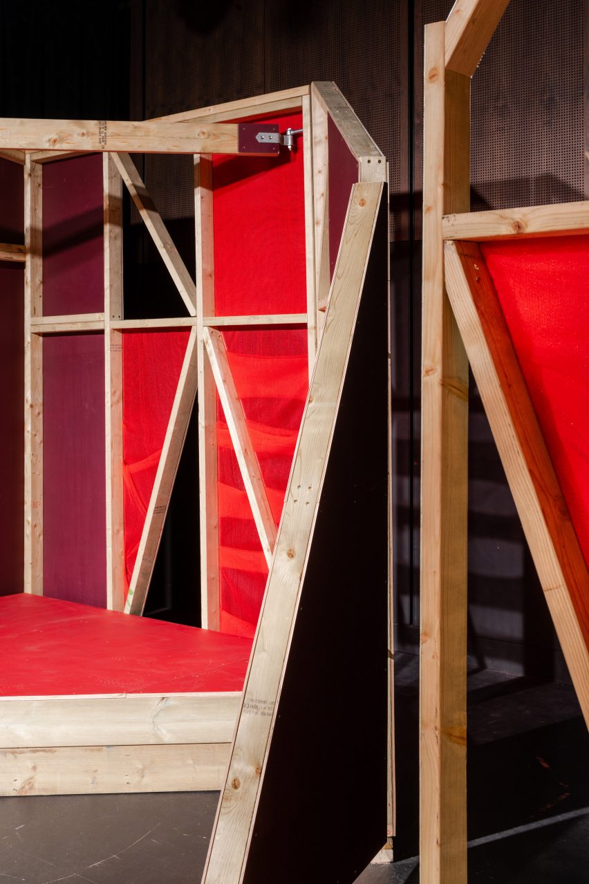 Triangular stages with timber frames and red netting built by school children and Matt+Fiona