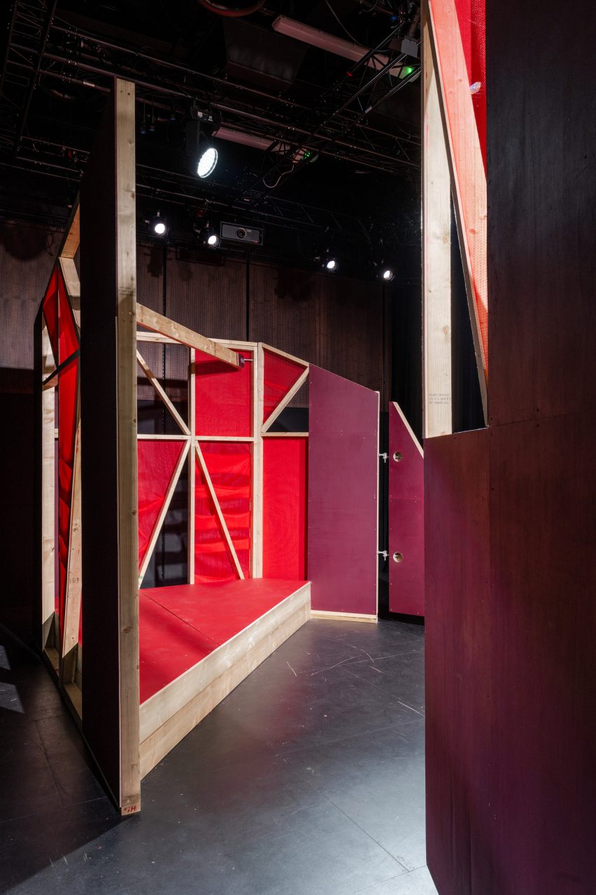 Triangular stages with timber frames and red netting built by school children and Matt+Fiona