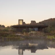 Rain harvesting house at dusk with reflection