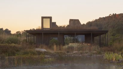 Rain harvesting house at dusk with reflection