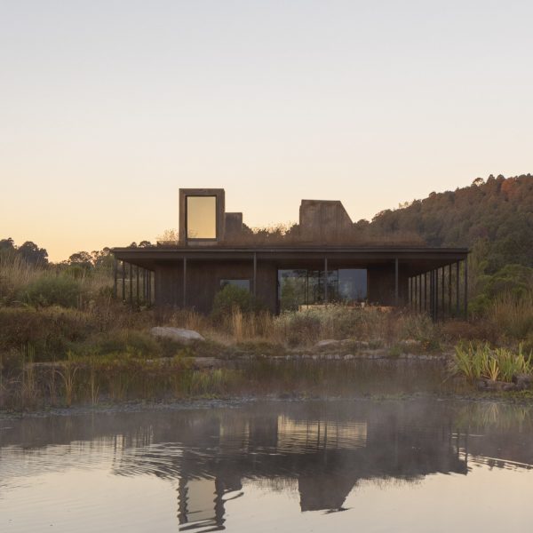 Rain harvesting house at dusk with reflection