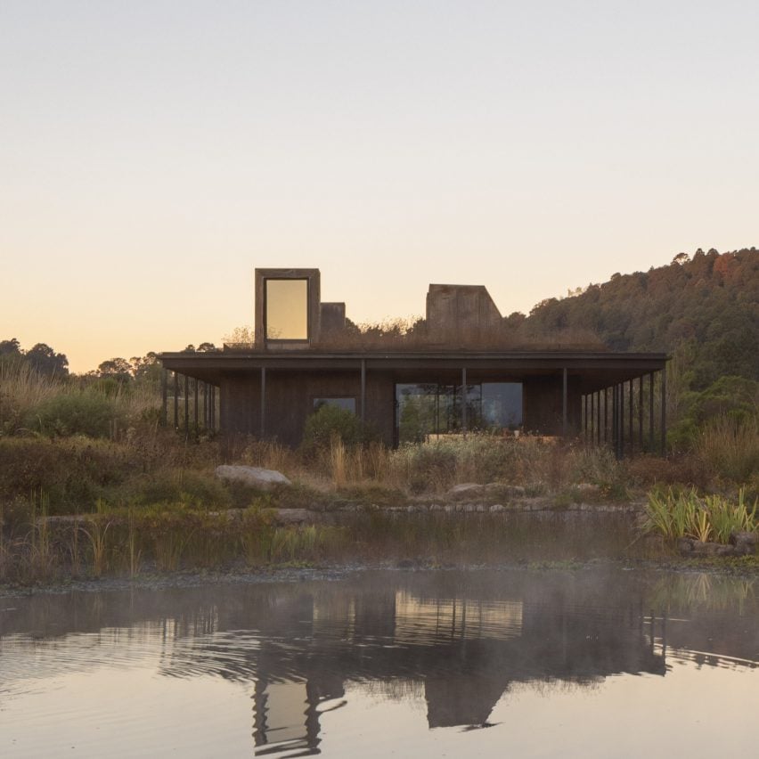 Rain harvesting house at dusk with reflection