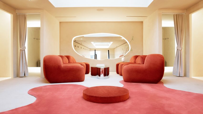 Fitting room lounge with red satin furniture and carpet