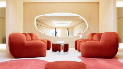 Fitting room lounge with red satin furniture and carpet