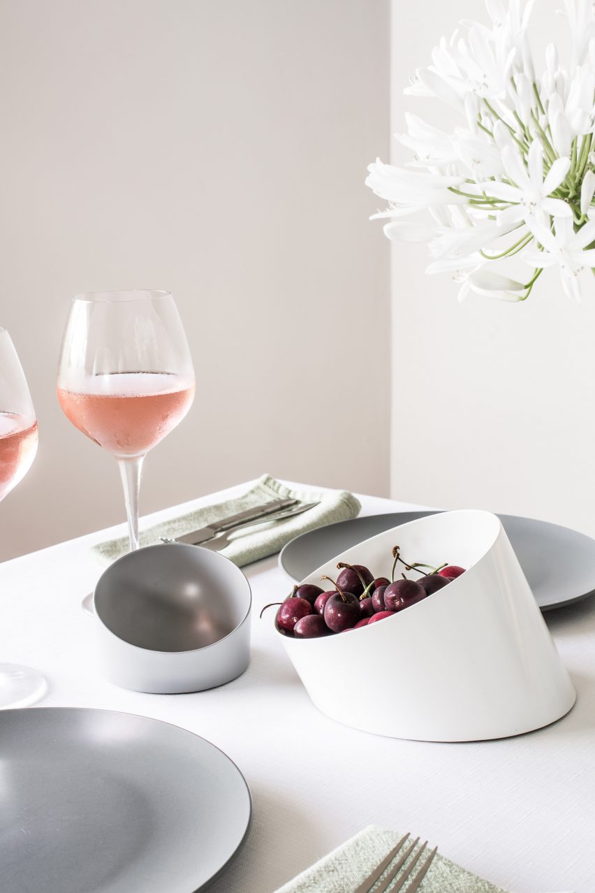 Slanted bowl containing cherries on table