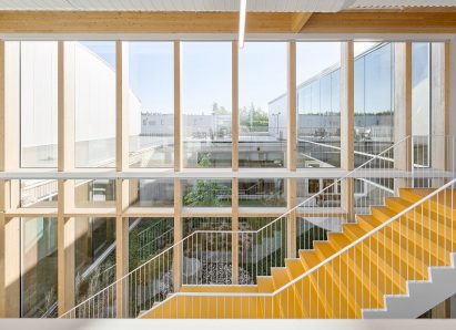 Central staircase next to large floor-to-ceiling windows