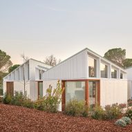 A cluster of mono-pitched square structures comprising House 016 by Arquitecturia