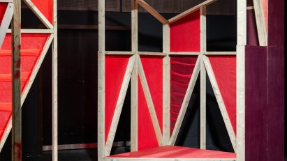 Triangular stages with timber frames and red netting built by school children and Matt+Fiona