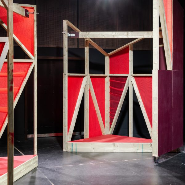 Triangular stages with timber frames and red netting built by school children and Matt+Fiona