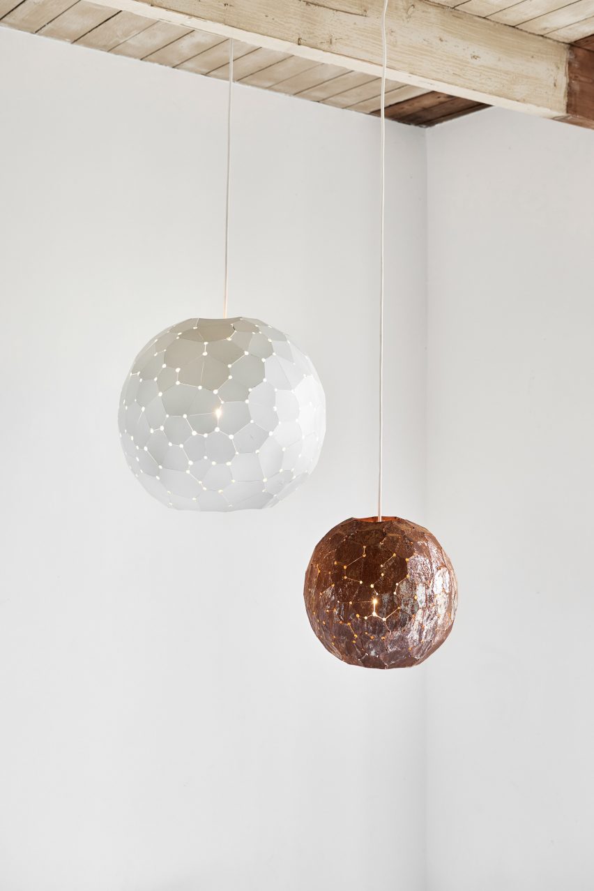 Spherical lamp shades in front of white wall