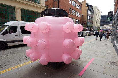 Pink inflatable sculpture with bulbous protrusions