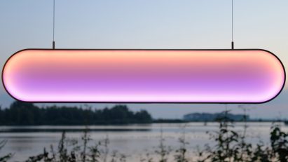 Pink and orange light hanging in front of lake view
