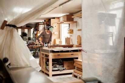 Designer working on wood for Three exhibition
