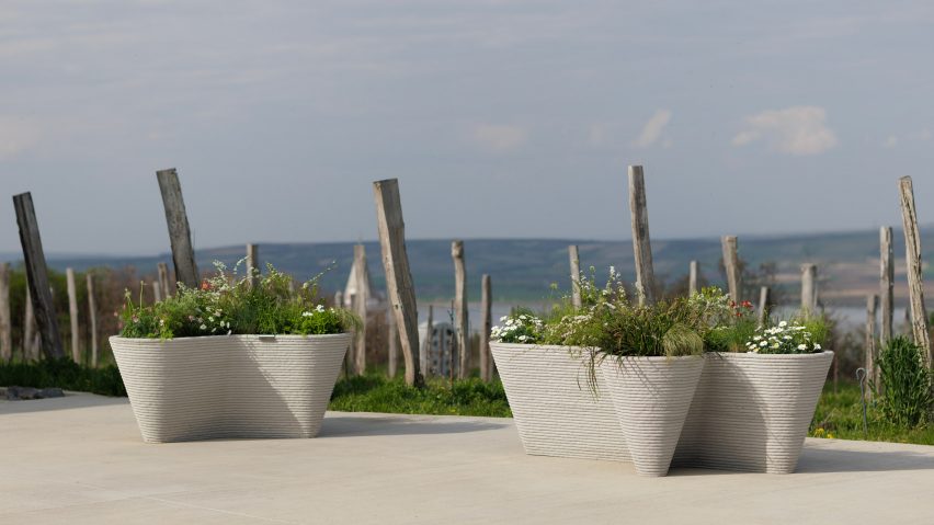 Planters on gravel in front of sea view
