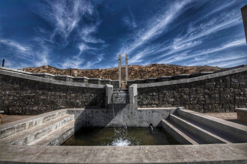 A square dam with perimeter steps leading to it